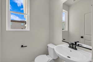 Half bath with toilet and a sink