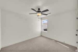 Empty room with carpet floors and a ceiling fan