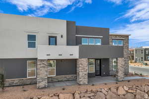 View of front of property with stucco siding and stone siding