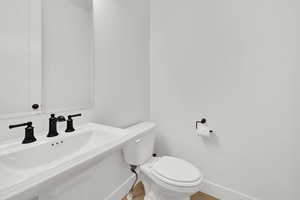 Bathroom with toilet and baseboards