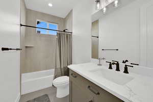 Full bath featuring vanity and shower / bath combo with shower curtain