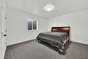 Carpeted bedroom with baseboards