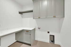 Laundry room featuring washer hookup, hookup for an electric dryer, cabinet space, and light wood-type flooring