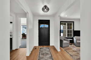 Entrance foyer featuring light wood finished floors and recessed lighting