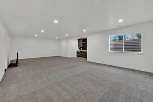 Unfurnished living room featuring light colored carpet and recessed lighting
