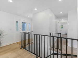 Entryway featuring a white door with decorative glass inserts and matching sidelights