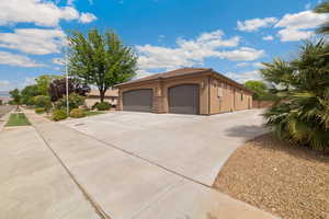 View of home's exterior featuring stucco siding, concrete driveway, an attached garage, stone siding, and a tiled roof