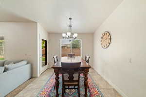 Dining room featuring baseboards and suspended lighting