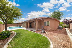Rear view of house featuring stucco siding, a patio, and a fenced backyard