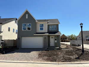 View of front of property featuring a garage, roof with shingles, driveway, and a residential view