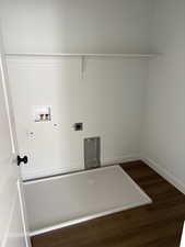 Laundry area featuring dark wood-style floors, washer hookup, and hookup for an electric dryer
