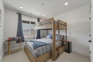 Bedroom with light carpet and recessed lighting