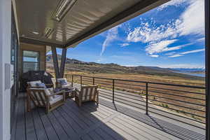 Deck with a mountain view, area for grilling, and an outdoor hangout area