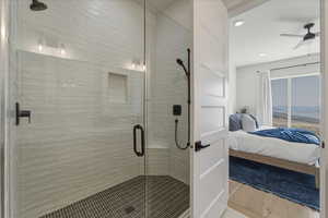 Full bathroom featuring ensuite bath, a shower stall, a ceiling fan, light wood-type flooring, and recessed lighting