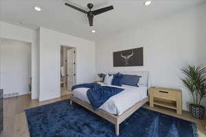 Bedroom featuring wood finished floors, ceiling fan, recessed lighting, and connected bathroom
