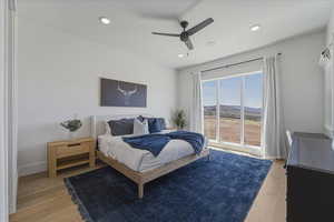 Bedroom featuring light wood-type flooring, a ceiling fan, recessed lighting, and a mountain view