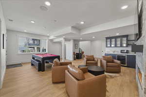 Playroom with wine cooler, light wood-style flooring, bar, billiards table, and recessed lighting