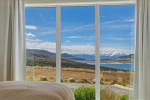 Bedroom with a water and mountain view