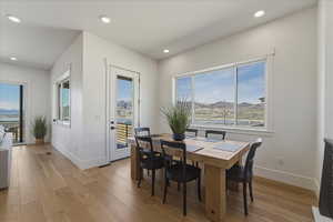 Dining area featuring light wood-style flooring, healthy amount of natural light, recessed lighting, and a mountain view