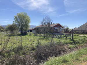 View of front of property with a chimney and stone siding