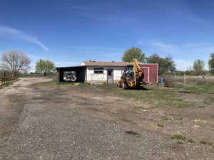 View of outdoor structure featuring driveway and a carport