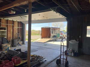 Miscellaneous room with unfinished concrete floors and a garage