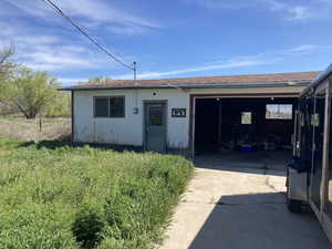 View of front of property featuring stucco siding and a shingled roof