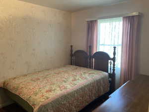 Bedroom with wallpapered walls