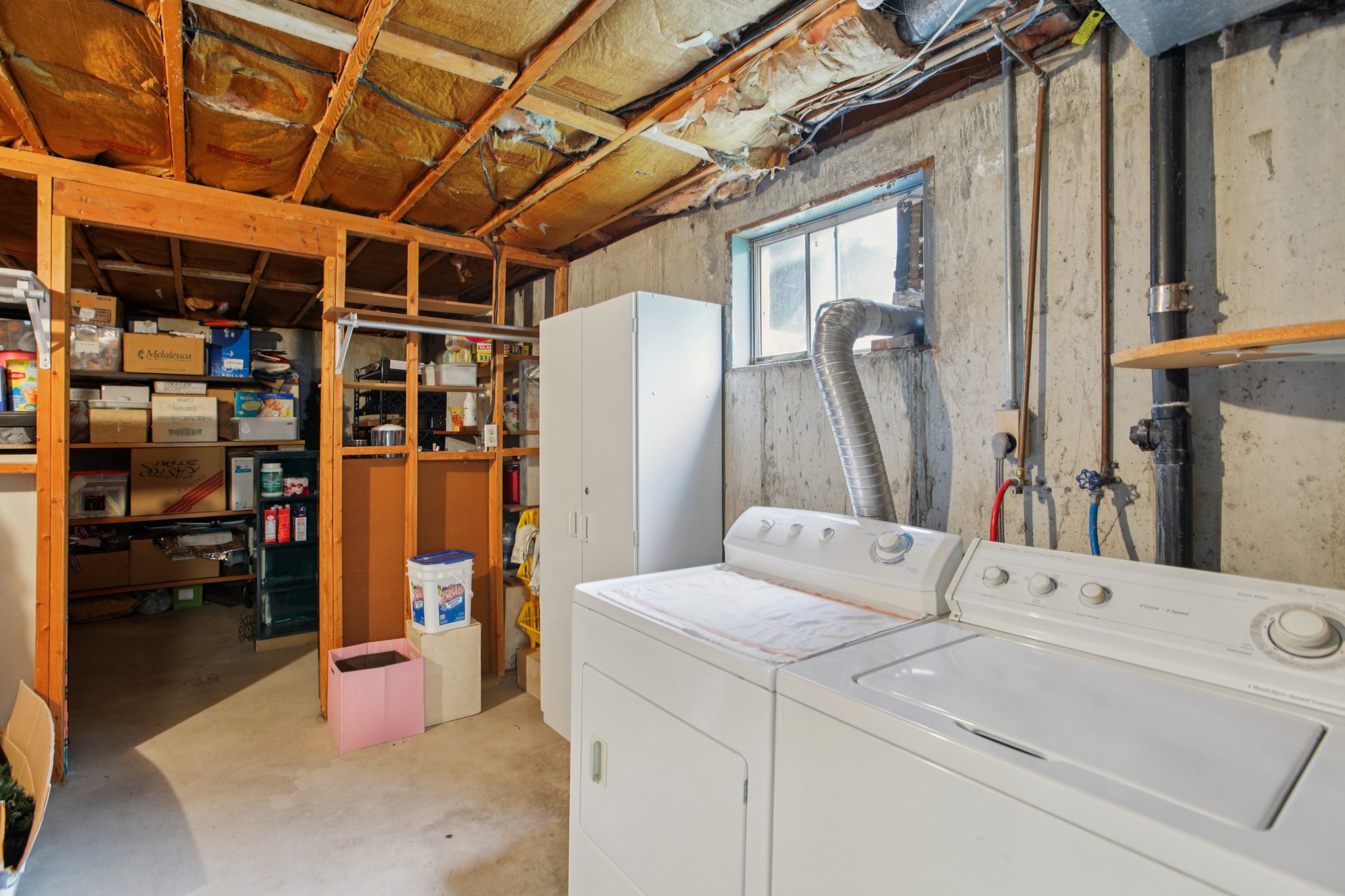 Laundry area with concrete flooring and washer and clothes dryer