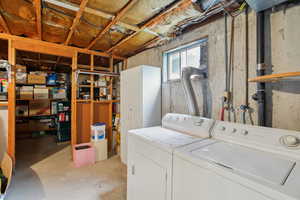 Laundry area with concrete flooring and washer and clothes dryer