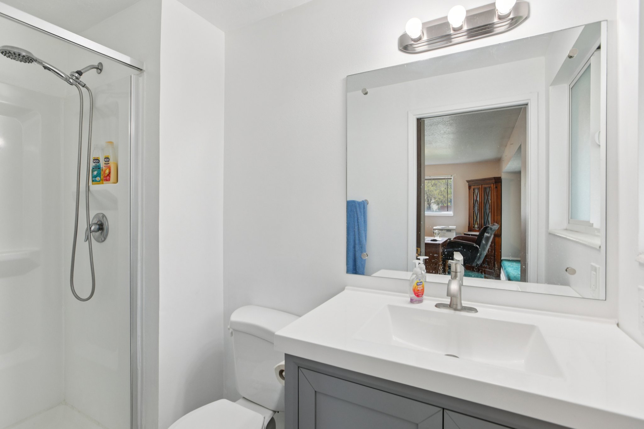 Full bathroom with vanity, a shower stall, and ensuite bath