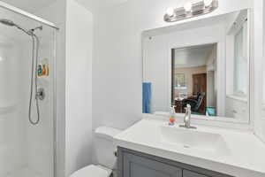 Full bathroom with vanity, a shower stall, and ensuite bath