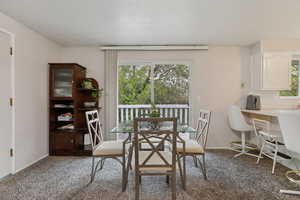 Dining space featuring light carpet and baseboards