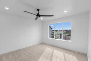 Unfurnished room with light colored carpet, ceiling fan, and recessed lighting