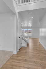 Hall with light wood-style floors, recessed lighting, and a mountain view