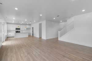 Unfurnished living room with recessed lighting and light wood-style floors