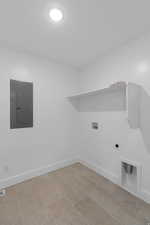 Laundry area featuring electric panel, washer hookup, and hookup for an electric dryer