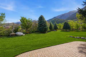 View of green lawn featuring a mountain view