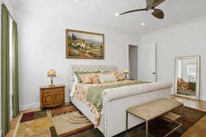 Master bedroom featuring crown molding, and double closets