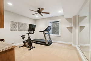 Office / workout area with built in study area, recessed lighting, arched walkways, and light