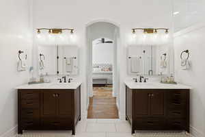 Master bath with two vanities, walk in shower, jetted tub, and marble finishes