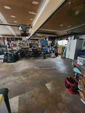 Garage with a workshop area and white refrigerator with ice dispenser