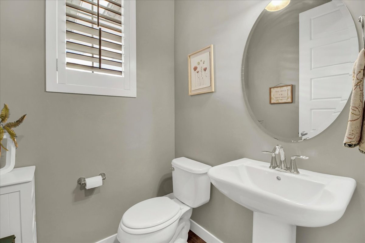 Half bathroom with toilet and baseboards