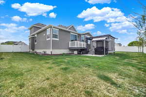 Rear view of property featuring a gazebo, a patio area, a fenced backyard, and stucco siding