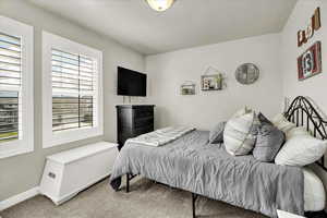 Bedroom featuring carpet floors and baseboards