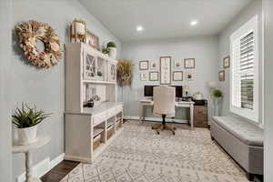 Office area with recessed lighting and light wood-type flooring