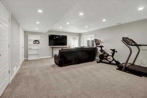 Exercise room featuring light colored carpet and recessed lighting