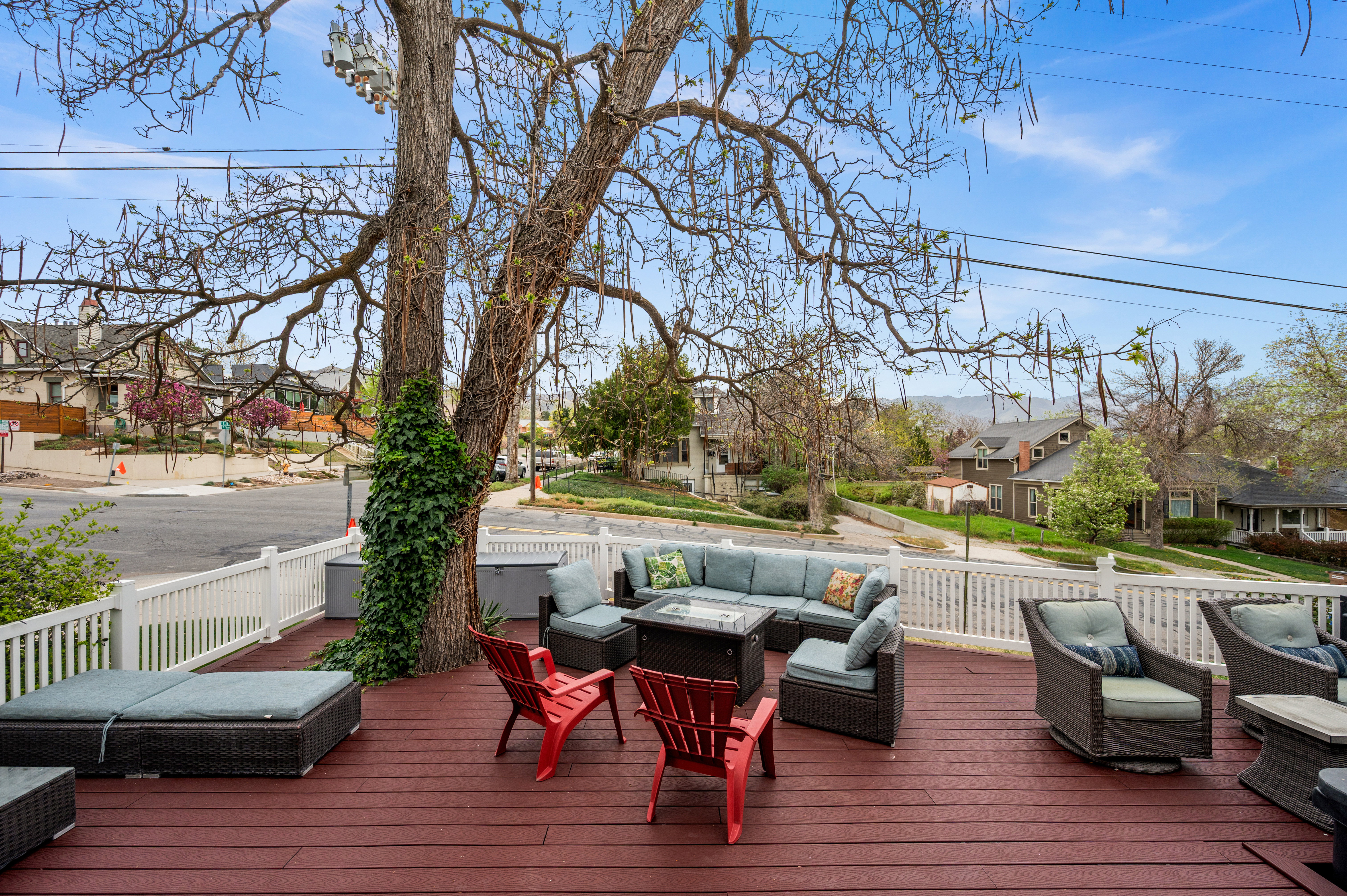 Wooden deck featuring an outdoor living space with a fire pit and a residential view