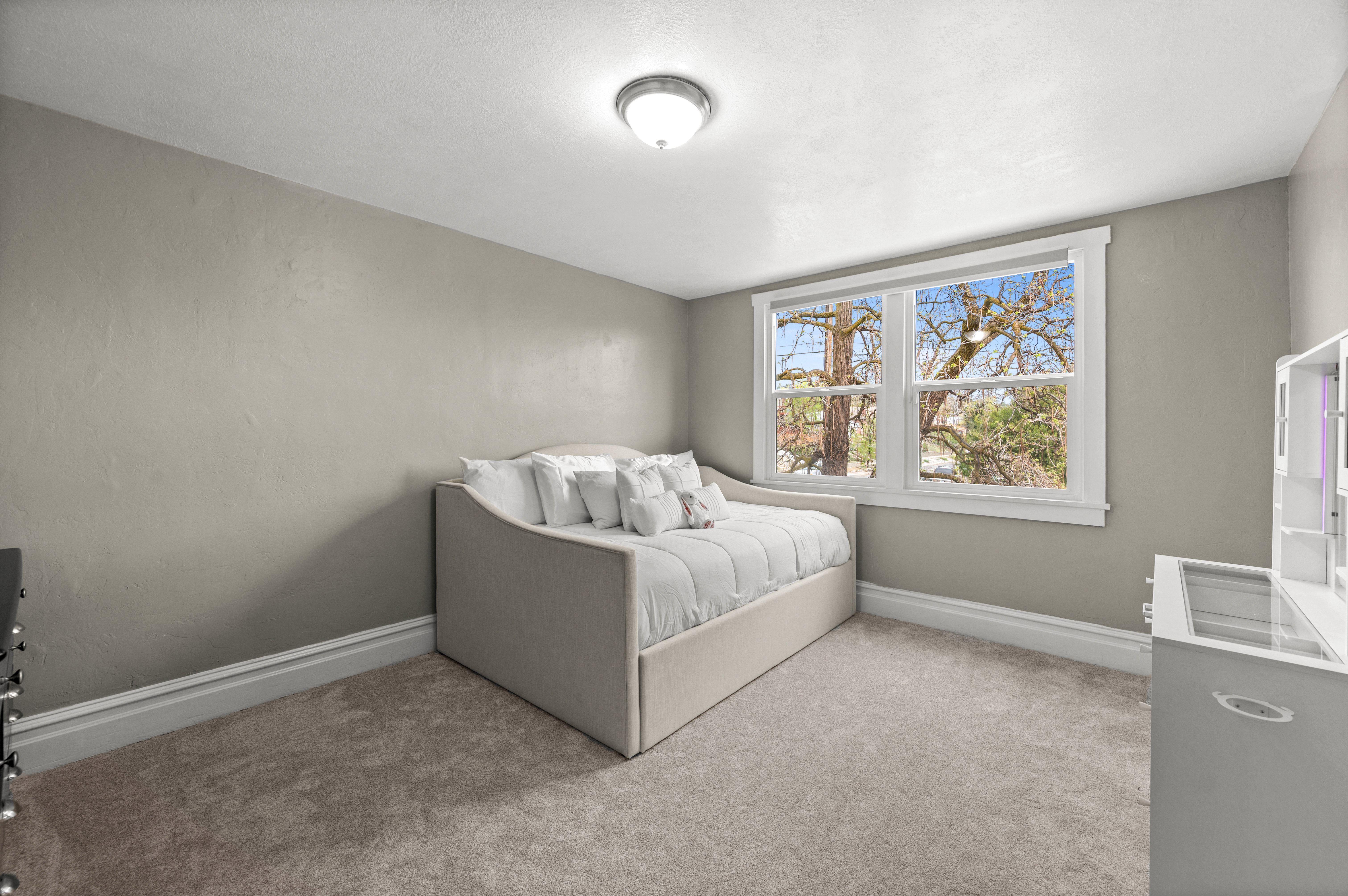 Bedroom with light carpet and baseboards