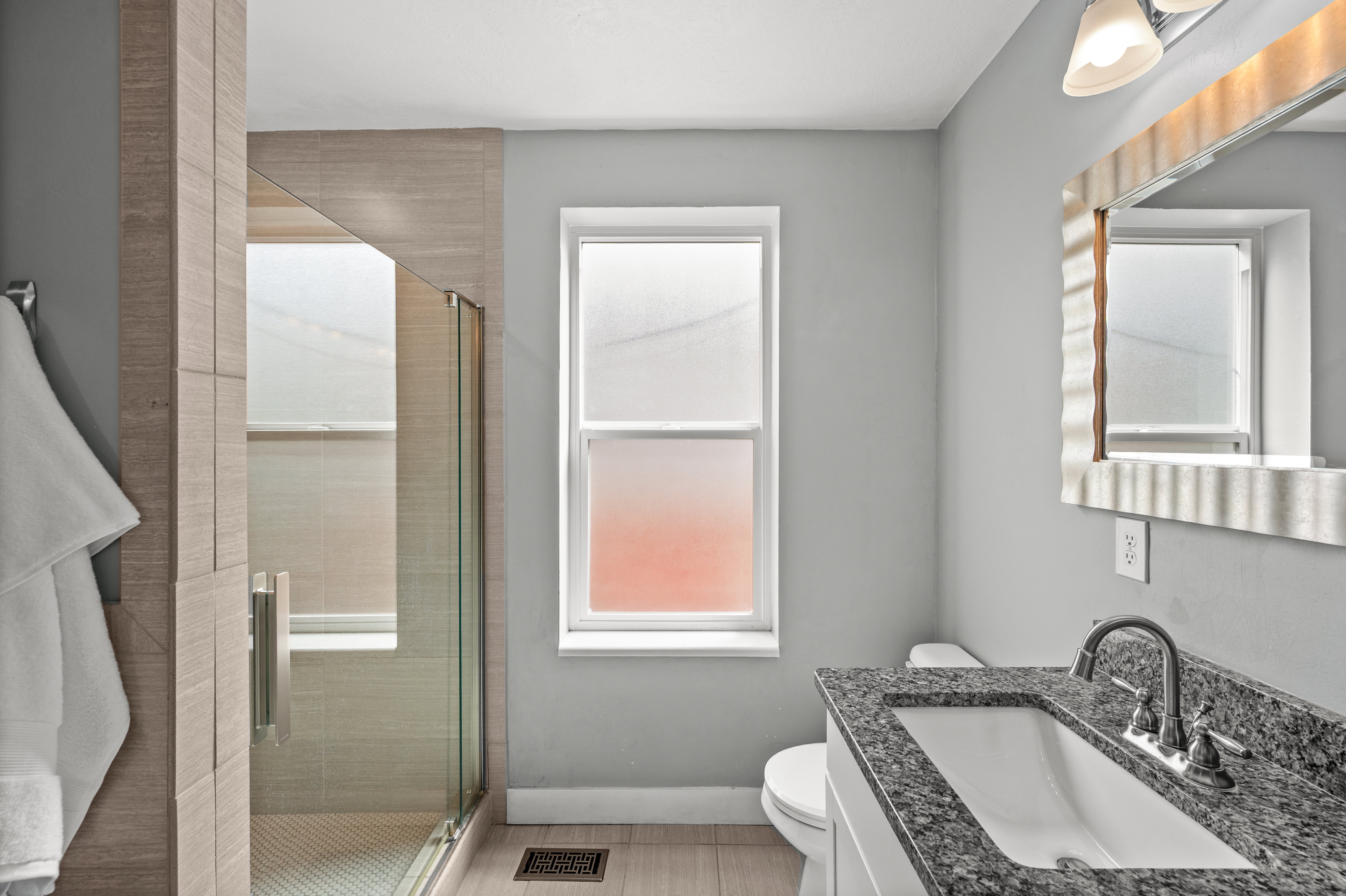 Full bath with a stall shower and vanity